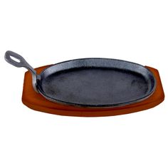 an empty cast iron skillet sitting on a wooden plate with handles and wood base