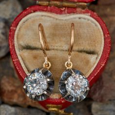 These pretty circa late Victorian earrings are each accented with one (1) old European cut diamond set into six-prong dangle sterling silver settings . The earrings are finished with 14K yellow gold wire backs for pierced eras. The earrings measure 24.2 mm in length and 9.5mm in width. Old Earrings, Victorian Earrings, Diamond Dangle Earrings, European Cut Diamonds, Antique Earrings, Diamond Set, Gold Wire, October Birth Stone, High Quality Jewelry