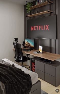 a bedroom with a bed, desk and television on the wall next to an open bookcase