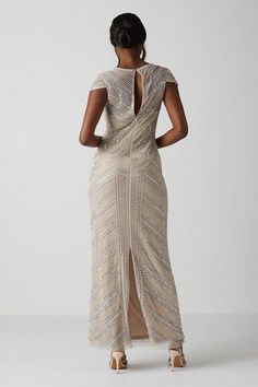 Inspired by the intricate designs of the art deco movement, this unconventional gown is guaranteed to make a statement. This body-contouring design features cap sleeves, a cut-out detail at the back, showing just a hint of skin and a rear slit to allow for ease of movement as you walk down the aisle. Made from embellished sequins: exquisitely ornated with hand-sewn beads, this luxurious fabrication has a heavyweight feel, encasing your figure for a sculptural silhouette. Every unique pattern is created exclusively in-house by a team of artists. Level of stretch: none. This dress fastens with a rear concealed zip. Walk Down The Aisle, Art Deco Movement, Sleeve Maxi Dress, Walking Down The Aisle, Body Contouring, Maxi Dress With Sleeves, Fashion Face, Cap Sleeve, Unique Patterns