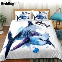 the bedding is decorated with dolphins and blue watercolors on it's sheets