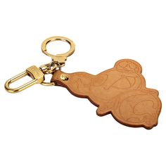 a wooden keychain with an image of a cartoon character on the front and back