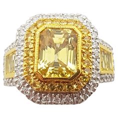 Yellow Sapphire 3.30 carats with Yellow Sapphire 1.12 carats and Diamond 0.45 carat Ring set in 18 Karat White Gold Settings Width: 1.4 cm Length: 1.6 cm Ring Size: 53 Total Weight: 10.53 grams "We first opened doors in 1980 when it was then situated in the vicinity of the Victory Monument; a small and modest storefront with a couple of counters. From its humble beginnings to where it stands today, our company has proven its abilities as a jeweler. Since the beginning, we have been supplying fin Yellow Emerald Cut Diamond Ring With Halo Setting, Gia Certified Yellow Baguette Cut Ring, Yellow Baguette Cut Diamond Ring With Vvs Clarity, Black Diamond Solitaire Ring, Canary Diamond, Black Diamond Solitaire, Rainbow Sparkle, Solitaire Ring Set, White Gold Sapphire