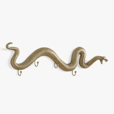 a metal hook with a snake on it's side and two hooks attached to it