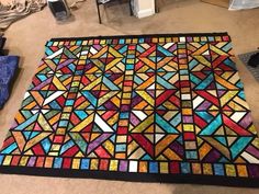 a very colorful rug on the floor in a room