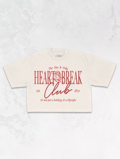 Join the Heart Break Club in our Tennis Club inspired varsity, cropped t-shirt, perfect for Valentine's Day & every day after. - Features the phrase "Heart Break Club" with an angel in the center and the phrase "the one & only" above & "it's not just a holiday, it's a lifestyle" underneath all in a red ink across the front - Screen print transfer that is heat pressed onto each tshirt - Tshirt is a high quality, garment dyed, vintage wash that gets softer after each wash - Regular size fit croppe Valentines Day Tees, Tattoo Shop Merch, Varsity Shirt Design, T Shirt Typography Design, Club Tshirt Designs, Tour Tshirt Design, Street Wear Tshirt Design, Oversized Cropped Tshirt, Cool Tshirt Designs