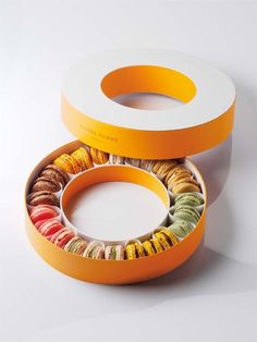 an orange box filled with different types of donuts