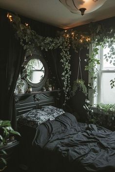 a bedroom with black walls and plants growing on the window sill over the bed