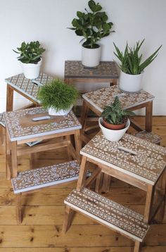 three wooden tables with plants on them