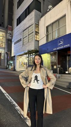 a woman is standing in the middle of an empty street with her hands on her hips