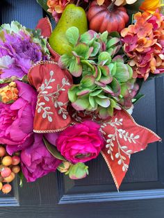 a bouquet of flowers and fruit on the front door