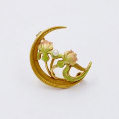 "A darling 14K gold Art Nouveau era crescent and lotus flower pin by Newark, NJ jewelry house Krementz. Known for their delicate enamel work, this antique pin is the perfect example of their fine craftsmanship. The gradient enameling from green to pink shown in the flower is really quite lovely. The back of the pin is stamped \"14K\" with the maker's mark as well. Metal: 14K Yellow Gold Weight: 2.5 grams Pearl: 2.3 mm Measurements: 0.8 inches long by 0.9 inches wide Markings: \"14K\" and maker's Lalique Jewelry, Bijoux Art Nouveau, Antique Pins, Art Nouveau Jewelry, Pin Pendant, Pearl Brooch, Enamel Flower, Gold Art, Flower Pins