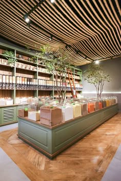 a room filled with lots of books and plants on shelves next to each other in front of a wooden ceiling