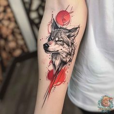 a tattoo with a wolf on the arm and watercolor paint splatters around it