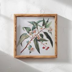 a painting hanging on the side of a wall with leaves and flowers painted on it