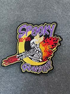 a sticker with the word spooky on it and a skeleton holding a baseball bat