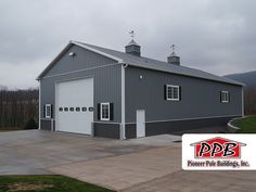 a large gray building with two garages on each side