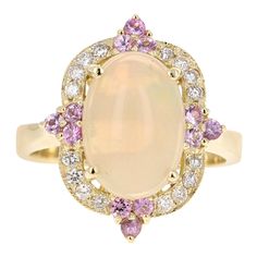 2.91 Carat Oval Cut Opal Diamond 18 Karat Yellow Gold Ring The Oval Cut Opal in this ring weighs 2.30 Carats and the measurements of the Opal are 8 mm x 12 mm. The Opal is surrounded by 4 Pink Sapphires that weigh 0.37 carats and also 16 Round Cut Diamonds that weigh 0.24 Carats. (Clarity: VS, Color: H) The total carat weight of this ring is 2.91 Carats. The beautiful ring is set in 18 Karat Yellow Gold and weighs 7.4 grams. The ring is a size 7 and can be re-sized if needed at no additional cos Sapphire Cocktail Ring, Diamond Cocktail Rings, Purple Rain, Yellow Gold Ring, Beautiful Ring, Jewelry Companies, Cluster Ring, Round Cut Diamond, Pink Sapphire