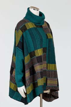 Liv by Habitat's Brooklyn Sweater is a loose, wide, sleeved poncho style sweater with a color block plaid pattern. This mid-weight sweater has a ribbed cowl neck, dropped shoulders, and ribbed tight sleeves. Oversized A-line silhouette in a soft wool blend. Easy to throw on over any bottom for all day cozy comfort. Falls over the hips on most. No pockets.Made in ChinaFabric: 75% Acrylic, 15% Wool, 10% NylonCare: Hand Wash, Dry Flat See Liv by Habitat Sizing Guideline Here >Measurements - Approxi