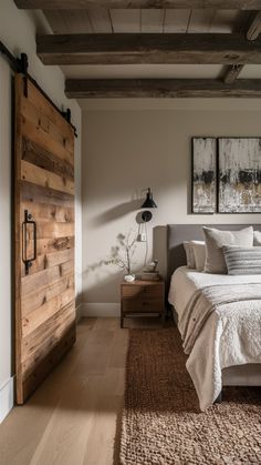 a bedroom with a bed, dresser and two pictures hanging on the wall above it