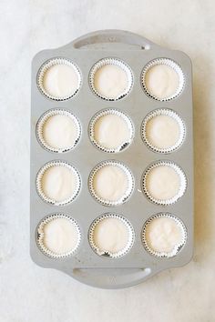 a muffin pan filled with cupcakes sitting on top of a white counter