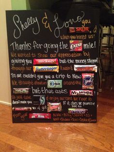 a chalkboard sign with candy and love you shop written on it in front of a kitchen counter