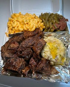 there are three different types of food in the box on the table, including macaroni and cheese