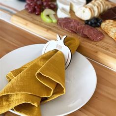 a white plate topped with food on top of a wooden table next to a cutting board