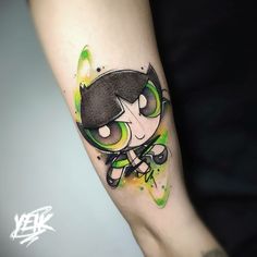 a cartoon character tattoo on the left arm and leg, with green paint splattered over it