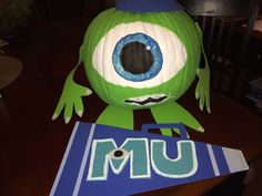 a green monster made out of paper with the word mum on it's face