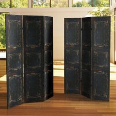 an open room divider sitting on top of a hard wood floor next to a window