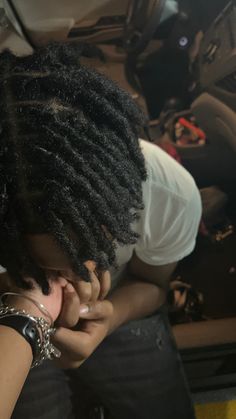 a woman with dreadlocks sitting in a car