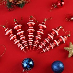 red and white striped christmas ornaments on a red background