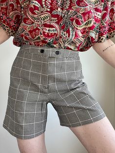 Let There Be Shorts. 80s Tartan Plaid Shorts in Black & Cream. Size 6. Fits M best. Please refer to measurements below. Made in Taiwan. Poly, Rayon, Spandex Blend. One pocket on the side. And another li'l one in front. Great Preloved Condition.  The colors of the photographs may differ slightly from the actual item colors. Measurements were taken with item laying flat, and are approximate. Waist: 14.5" Rise: 12" Length: 16" Hips: 19" Please message questions prior to purchase- I'm happy to help. Once shipped, sales are final, no return/exchange. But please contact me if you have any problems with your order. Thanks! Shown on a 5'8" 34B. Vintage High Waist Shorts For Workwear, Vintage High-waist Shorts For Work, High Waist Vintage Shorts For Workwear, Vintage Short Bottoms For Workwear, Retro Fitted Short Bottoms, Retro Black Short Length Bottoms, Vintage Stretch Short Length Bottoms, Retro Black Short Bottoms, Black Vintage Fitted Shorts