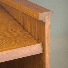 a close up view of the corner of a wooden cabinet