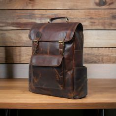 Personalized Leather Backpack, Travel Backpack Rucksack, Brown Leather Roll Top Backpack, Laptop Bag, Unisex Bag If you have any query then just message me and get response within 5 minutes. Happy Shopping.. ● * Description of the Backpack  * ● * Dimensions: 12 x 16 x 5 Inches || 30 x 40 x 13 CMs. ( L x H x W) * The Backpack is crafted out of the premium quality of Buffalo leather. *  Polyester lining * The Backpack contains 2 spacious compartments for books, files and a laptop. One of the compa Vintage Brown Backpack For On-the-go, Vintage Satchel Backpack For On-the-go, Vintage Travel Backpack With Adjustable Strap, Vintage Rectangular Backpack With Adjustable Strap, Vintage Satchel Backpack With Large Capacity, Vintage Leather Shoulder Backpack For Travel, On-the-go Waxed Satchel Backpack, Vintage Large Capacity Standard Backpack, Classic Rectangular Backpack For Trips