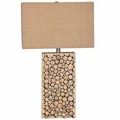 a lamp made out of wood with a beige shade