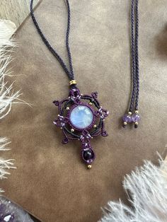 a purple necklace with an ornate design on it