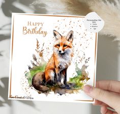 a hand holding up a card with an image of a fox