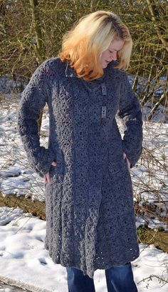 a woman standing in the snow with her hands on her hips and looking at something