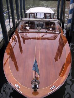 a wooden boat is docked at the dock