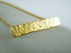 Gold dainty bar necklace Hammered bar necklace Gold Rectangle pendant Gold bar necklaceMinimalistic handmade and hammered gold rectangle bar pendant.Dainty and classic - the perfect casual jewelry !Pendant made from 24K gold micron plating (high quality thick and durable) hung on goldfilled chain. **The necklace can also be made in silver - Just mention it in your order**Rectangular pendant 1 1/2" (3.5cm)X6mmChain Length 17" (43cm)For more gold jewelry: https://www.etsy.com/il-en/listing/5255212 Gold Rectangular Bar Necklace For Gift, Gold Bar Necklace With Rectangular Pendant For Everyday, Yellow Gold Rectangular Bar Necklace, Gold Rectangular Minimalist Bar Necklace, Gold Minimalist Rectangular Bar Necklace, Dainty Gold Bar Necklace With Rectangular Pendant, Minimalist Gold Rectangular Bar Necklace, Minimalist Hammered Jewelry With Rectangular Pendant, Minimalist Hammered Rectangular Pendant Jewelry