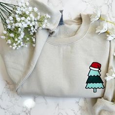 Embroidered Merry Christmas Sweater, Christmas Tree Sweatshirt - Embroidered Items are stitched to order. Please allow 1-2 weeks for items to ship.  - Unisex Crewneck Sweatshirt - Designed with pre-shrunk soft air-jet spun yarn - Loose fit for a comfortable feel * Sizing and Colors - Please refer to sizing and color charts in the images * Fabrication - 50% cotton, 50% polyester * Care Instructions - Turn inside out and machine wash cold on delicate cycle - Dry on low heat setting - Do not bleach - Do not dry clean - Do not iron directly on design * Processing and Shipping Times - Please allow 4-10 business days for your order to be processed and stitched - Standard shipping takes 3-5 days - Please note that these times are estimated by USPS and may take longer - Please make sure your shipp Embroidered Cotton Christmas Sweatshirt, Embroidered Christmas Holiday Sweatshirt, Christmas Holiday Embroidered Sweatshirt, Embroidered Christmas Sweatshirt, Embroidered Christmas Tree, Embroidered Items, Christmas Crewneck Sweatshirt, Embroidered Christmas, Christmas Crewneck