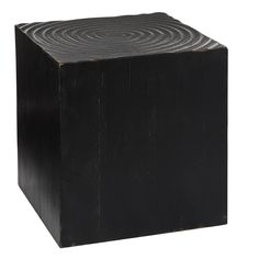 a square wooden block with spiral designs on the top and bottom, against a white background