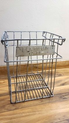 a metal basket on the floor with a plaque in it that reads r g a riverside