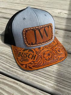 a trucker hat with the letter w on it sitting on top of a wooden table