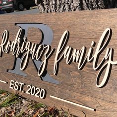 a wooden sign that says rockridge family est 2020 on it in front of a tree