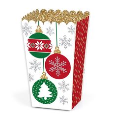 a christmas gift bag with ornaments hanging from it's sides and snowflakes on the top