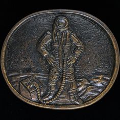 an old bronze medal with a man standing in the water