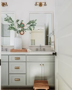 a bathroom with two sinks, mirrors and a stool in front of the sink area